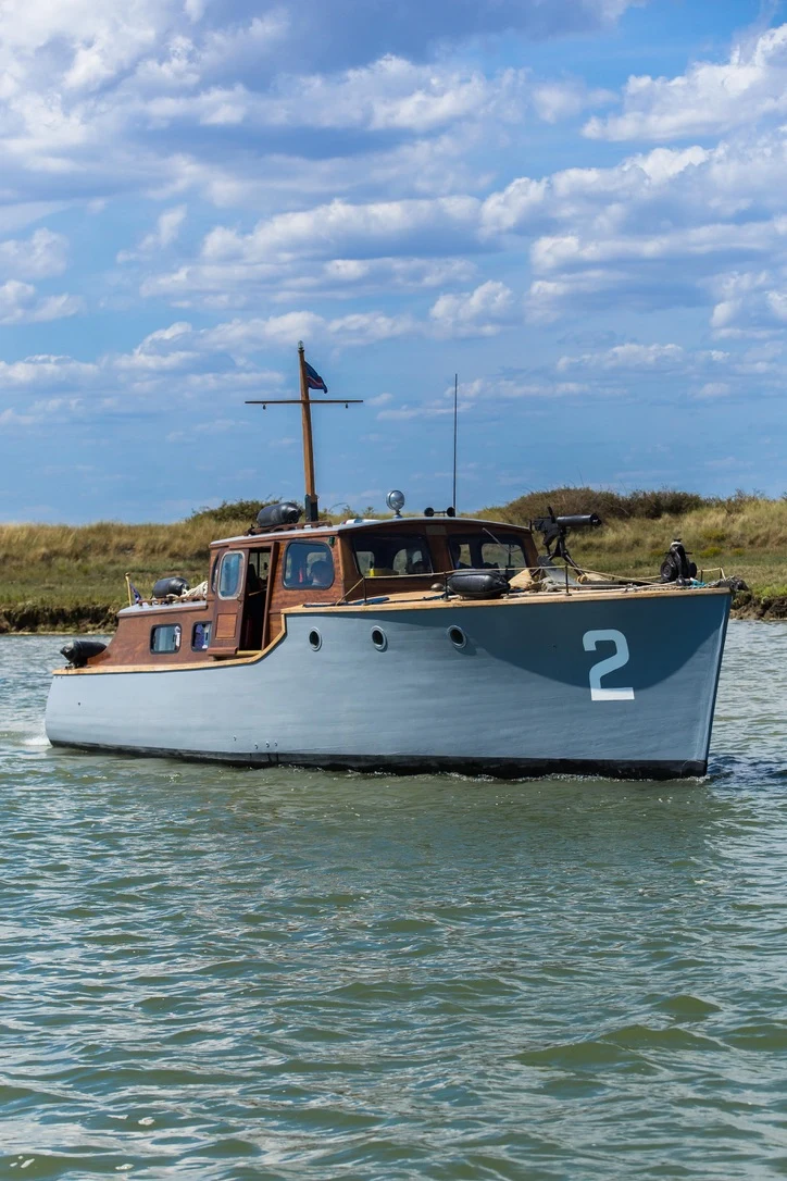 Starboard profile of Gerfalcon beneath a cloud-filled sky